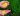 golden rice on the palm of a person in the field